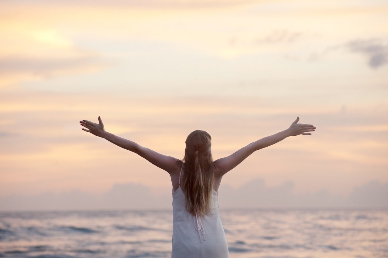 Happy Woman at the Beach with Spread Arms